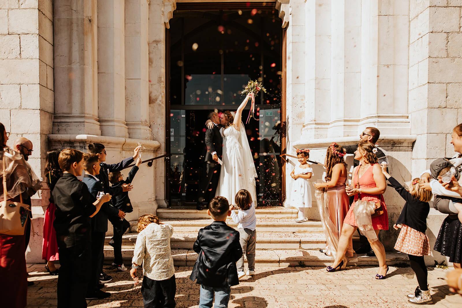 Flora & Luca Enfants lançant des confettis à la sortie de l'église